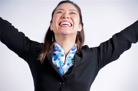 A very happy mixed race young woman with arms in  the air. Stock Photo - Budget Royalty-Free & Subscription, Code: 400-05285229