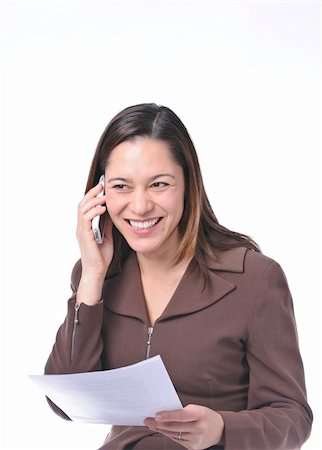 Young lady of filipino ethnicity,is sitting on stool with a white background.She is read a document.Also listening on the telephone and smiling with some good news. Stock Photo - Budget Royalty-Free & Subscription, Code: 400-05285232