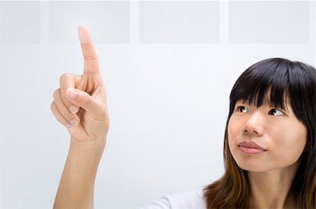 asian girl selecting from touch screen panel Stock Photo - Budget Royalty-Free & Subscription, Code: 400-05285946