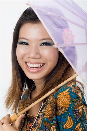 aian malay girl smiling with kebaya and umbrella Stock Photo - Budget Royalty-Free & Subscription, Code: 400-05285947