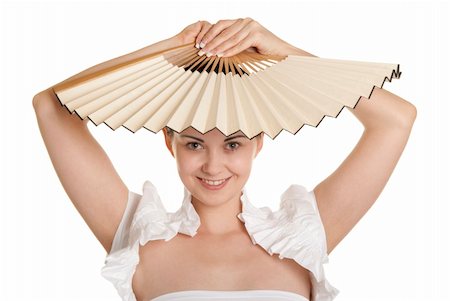 fantail - Young woman holds fan over head isolated in white. Stock Photo - Budget Royalty-Free & Subscription, Code: 400-05286142