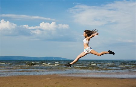 flying girl  Young woman making exercise on the beach. Stock Photo - Budget Royalty-Free & Subscription, Code: 400-05286434
