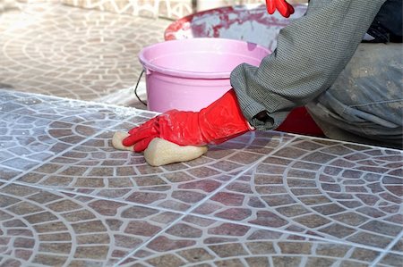 poured concrete construction - Close up of construction worker installing decorative tiles Stock Photo - Budget Royalty-Free & Subscription, Code: 400-05286892