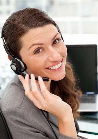 simsearch:400-04472832,k - Pretty female representative on the phone with earpiece on sitting at her desk Stock Photo - Budget Royalty-Free & Subscription, Code: 400-05287143