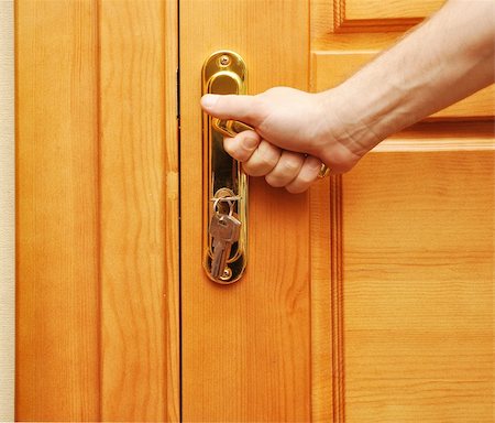 hand on a handle wooden door to open or close it Stock Photo - Budget Royalty-Free & Subscription, Code: 400-05287475