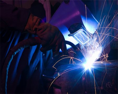 simsearch:640-03256647,k - Welder uses torch to make sparks during manufacture of metal equipment. Stock Photo - Budget Royalty-Free & Subscription, Code: 400-05287718