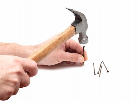 Hand with hammer nailing on white Fotografie stock - Microstock e Abbonamento, Codice: 400-05287948