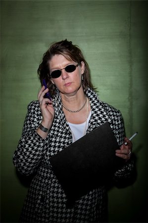 Woman smoking and talking on cellphone takes mugshot Stock Photo - Budget Royalty-Free & Subscription, Code: 400-05289348
