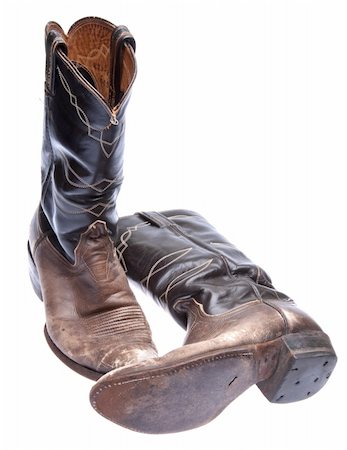 Pair of old worn cowboy boots isolated on white. Photographie de stock - Aubaine LD & Abonnement, Code: 400-05280186