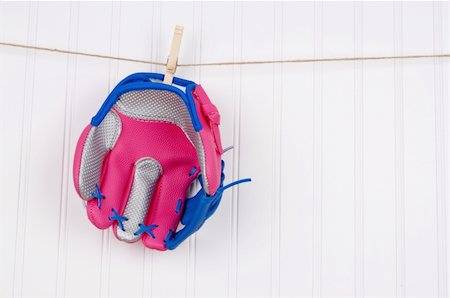 simsearch:400-04758470,k - Girl's Baseball Glove Hanging on a Clothesline. Photographie de stock - Aubaine LD & Abonnement, Code: 400-05280899