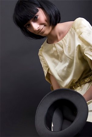 photographic portraits poor people - Young brunette holding an empty hat   symbolizing poverty and alms Stock Photo - Budget Royalty-Free & Subscription, Code: 400-05281352
