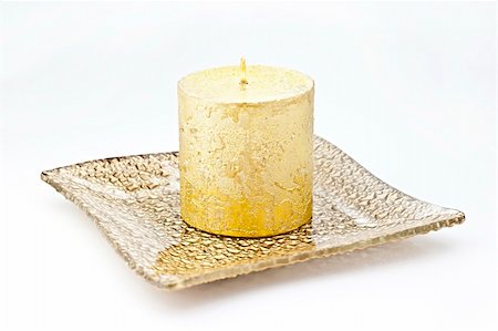 Isolated on white background gold candle in a glass dish. Fotografie stock - Microstock e Abbonamento, Codice: 400-05281563