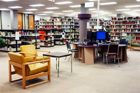 empty school chair - Computer station at the university college library with seating area in the foreground. One young female student searching far in the background. Stock Photo - Budget Royalty-Free & Subscription, Code: 400-05281734