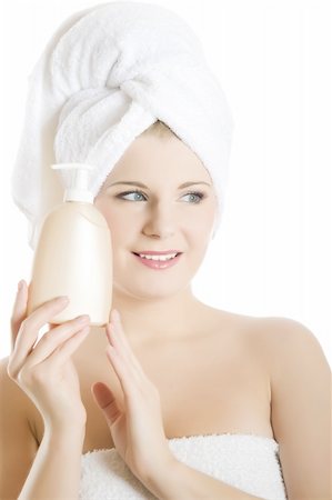 simsearch:400-04377849,k - Young beautiful woman with healthy pure skin and white towel on her head holding moisturizing body lotion Foto de stock - Super Valor sin royalties y Suscripción, Código: 400-05281730