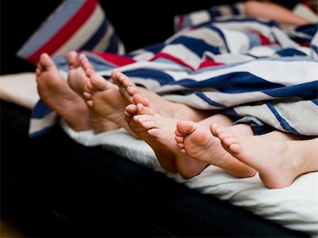 Family of four feet in the bed Stock Photo - Budget Royalty-Free & Subscription, Code: 400-05281822