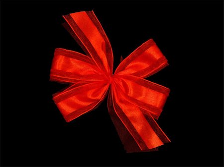 A red bow isolated against a black background Stock Photo - Budget Royalty-Free & Subscription, Code: 400-05281943