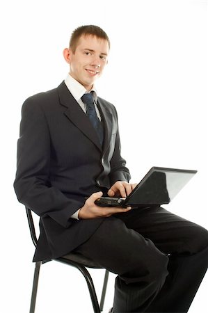 The businessman on the chair with laptop isolated on white background. Stock Photo - Budget Royalty-Free & Subscription, Code: 400-05282151