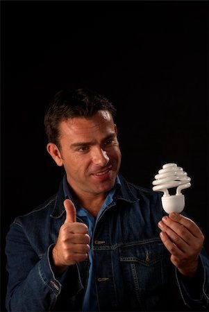 Attractive guy giving thumbs up to engergy saving bulb Stock Photo - Budget Royalty-Free & Subscription, Code: 400-05283765