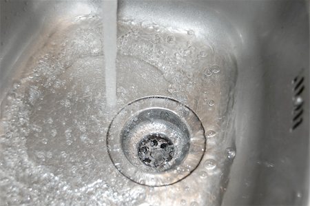 sink with bath bubbles - water flow into the drain in the kitchen Stock Photo - Budget Royalty-Free & Subscription, Code: 400-05295808