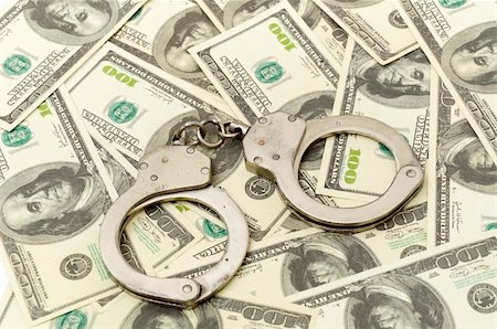 Handcuffs on money background, business security concept Stock Photo - Budget Royalty-Free & Subscription, Code: 400-05296503
