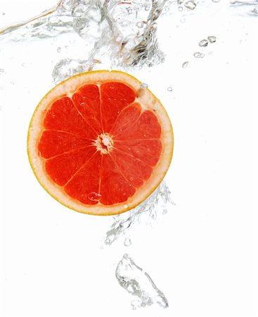 Fresh grapefruit dropped into water Stock Photo - Budget Royalty-Free & Subscription, Code: 400-05297476