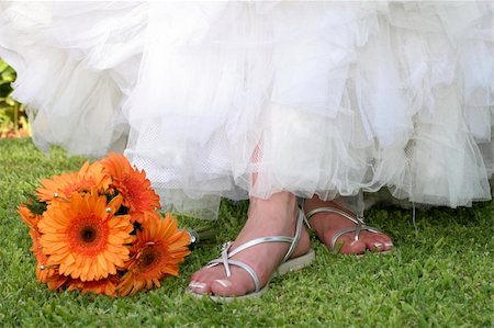 orange Gerbera bouquet next to bride's feet Stock Photo - Budget Royalty-Free & Subscription, Code: 400-05297508