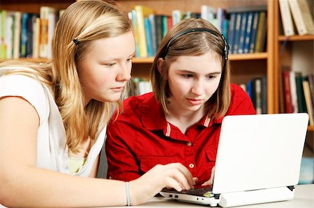 students reading book in classroom teen - Two serious students using the computer to do homework in the school library. Stock Photo - Budget Royalty-Free & Subscription, Code: 400-05298120