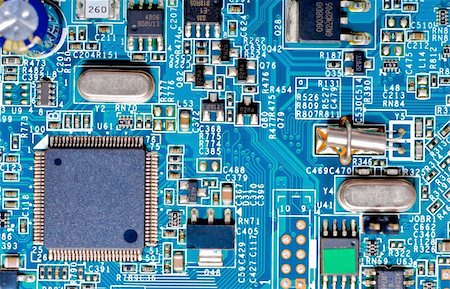 simsearch:695-05774962,k - Close-up photograph of the microchips and micro-electronic components on a blue circuit board Stockbilder - Microstock & Abonnement, Bildnummer: 400-05298171