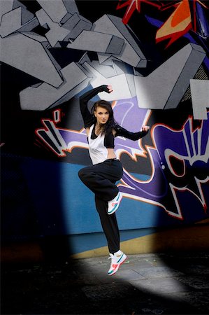 simsearch:400-04634435,k - young attractive woman in hip hop dress dancing and jumping in urban background Stock Photo - Budget Royalty-Free & Subscription, Code: 400-05298351