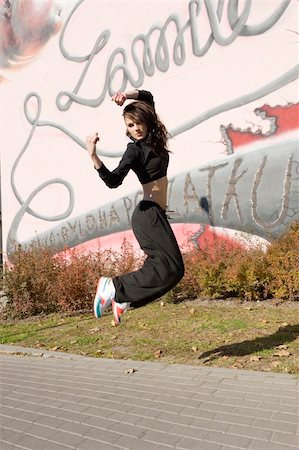 simsearch:400-04634435,k - young attractive woman in hip hop dress dancing and jumping in urban background Stock Photo - Budget Royalty-Free & Subscription, Code: 400-05298353