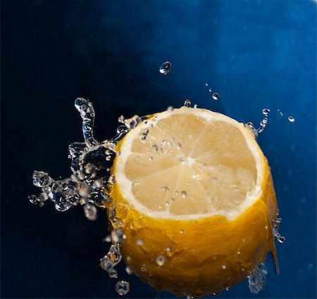 Water splash on a lemon on the white baclground. Stock Photo - Budget Royalty-Free & Subscription, Code: 400-05299837