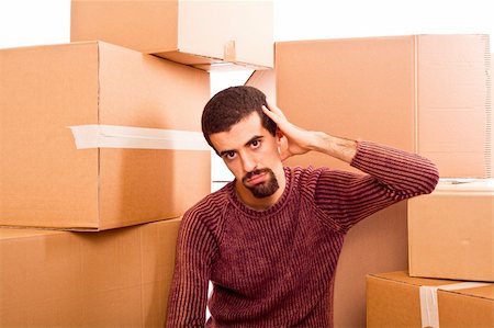 Stressed Young Man on Moving Swamped with Boxes Stock Photo - Budget Royalty-Free & Subscription, Code: 400-05291422