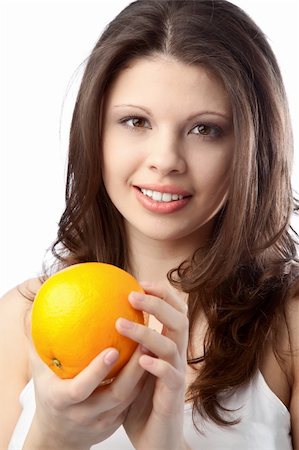 simsearch:400-04564926,k - Beautiful young woman holding an orange. Close up Photographie de stock - Aubaine LD & Abonnement, Code: 400-05291980