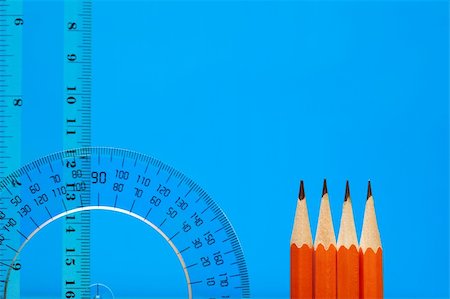 Transparent plastic protractor and ruler near pencils on blue background with copy space Foto de stock - Royalty-Free Super Valor e Assinatura, Número: 400-05292505