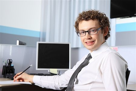 simsearch:400-04782151,k - Portrait of a young business man working at office Photographie de stock - Aubaine LD & Abonnement, Code: 400-05292638