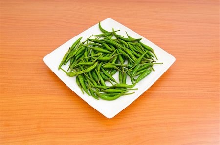 simsearch:400-04288181,k - Hot peppers in the plate on wooden table Photographie de stock - Aubaine LD & Abonnement, Code: 400-05292718