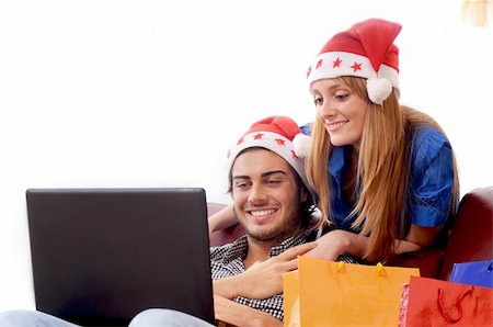 young couple in Christmas on-line shopping on white background Stock Photo - Budget Royalty-Free & Subscription, Code: 400-05293436