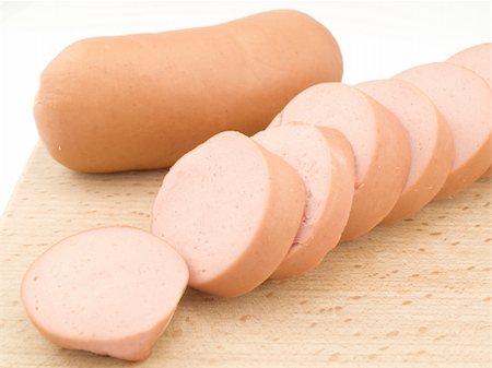 Two sausages on the wooden board, one of them is cut by rings Stockbilder - Microstock & Abonnement, Bildnummer: 400-05304042