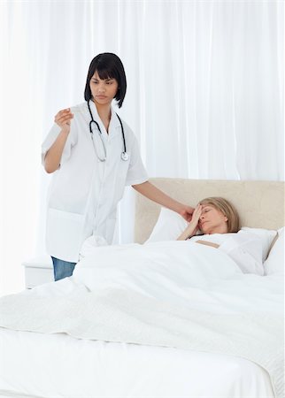 simsearch:400-04809124,k - Nurse taking the temperature of  her patient Stockbilder - Microstock & Abonnement, Bildnummer: 400-05304179