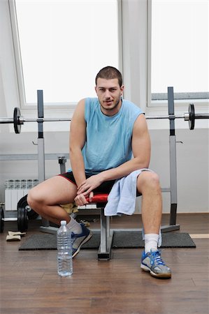 young man in fintess sport club exercise withweights and relaxing Stock Photo - Budget Royalty-Free & Subscription, Code: 400-05304713