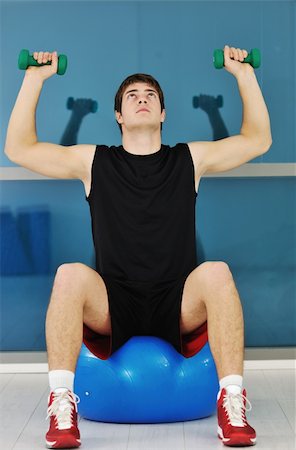 picture of a thin boy - young man in fintess sport club exercise withweights and relaxing Stock Photo - Budget Royalty-Free & Subscription, Code: 400-05304724