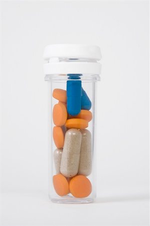 blue, orange and brown pills in a bottle Stock Photo - Budget Royalty-Free & Subscription, Code: 400-05304919