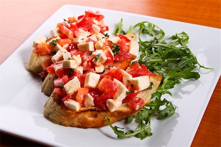 foccacia - Bruschetta with tomatoes and cheese Stock Photo - Budget Royalty-Free & Subscription, Code: 400-05305233