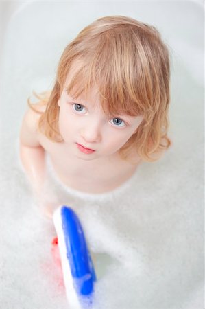 boy with long blond hair playing with plastic boat in bathtub Stock Photo - Budget Royalty-Free & Subscription, Code: 400-05305347