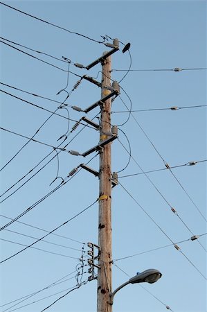 simsearch:400-04782405,k - Telegraph pole with a lot of wires over blue sky Photographie de stock - Aubaine LD & Abonnement, Code: 400-05305547