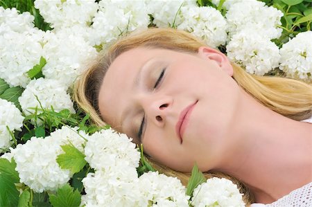 Young woman laying in flowers - snowballs Stock Photo - Budget Royalty-Free & Subscription, Code: 400-05305910