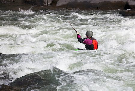 Canoeing in white water in rapids on river with the kayak starting to sink in the waves Stock Photo - Budget Royalty-Free & Subscription, Code: 400-05305988