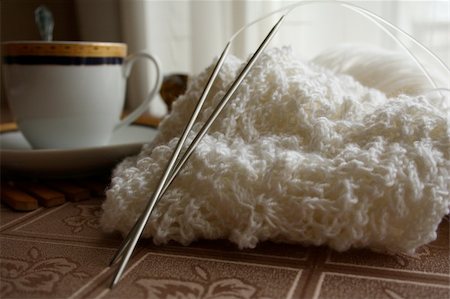 knitting needles, handiwork and a single tea set on a tablecloth Stock Photo - Budget Royalty-Free & Subscription, Code: 400-05306177