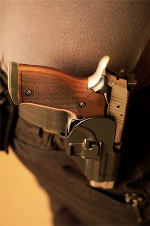 simsearch:640-01364505,k - Pistol in a holster on a belt of the man Fotografie stock - Microstock e Abbonamento, Codice: 400-05306985