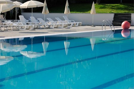 blue water with reflection at hotel resort swimming pool outdoor at sunny day Foto de stock - Super Valor sin royalties y Suscripción, Código: 400-05307089